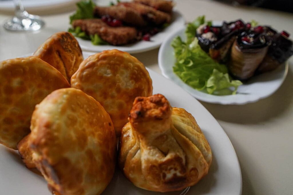 Plate of several large fried khinkali Georgian soup dumplings