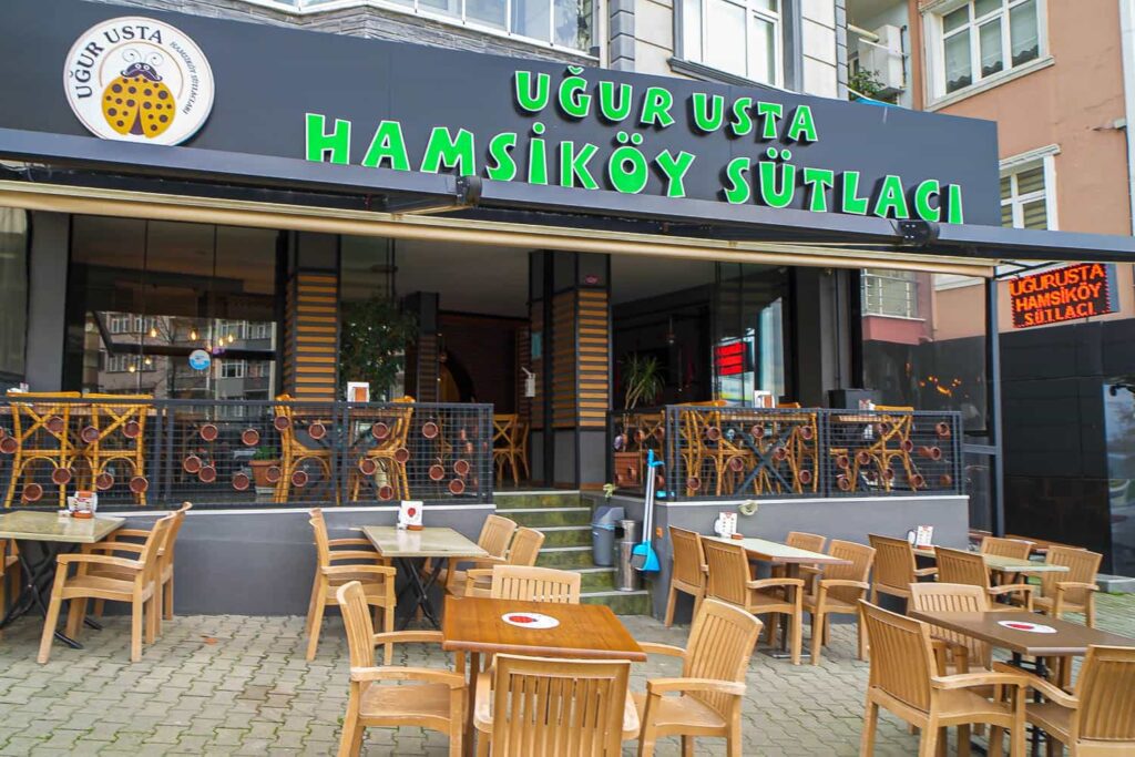 The outside of a Turkish rice pudding restaurant in Trabzon with tables and chairs on the patio