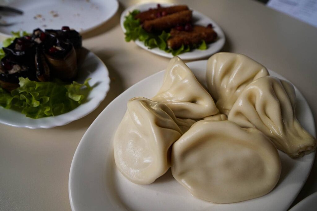 Plate of large Georgian soup dumplings on table