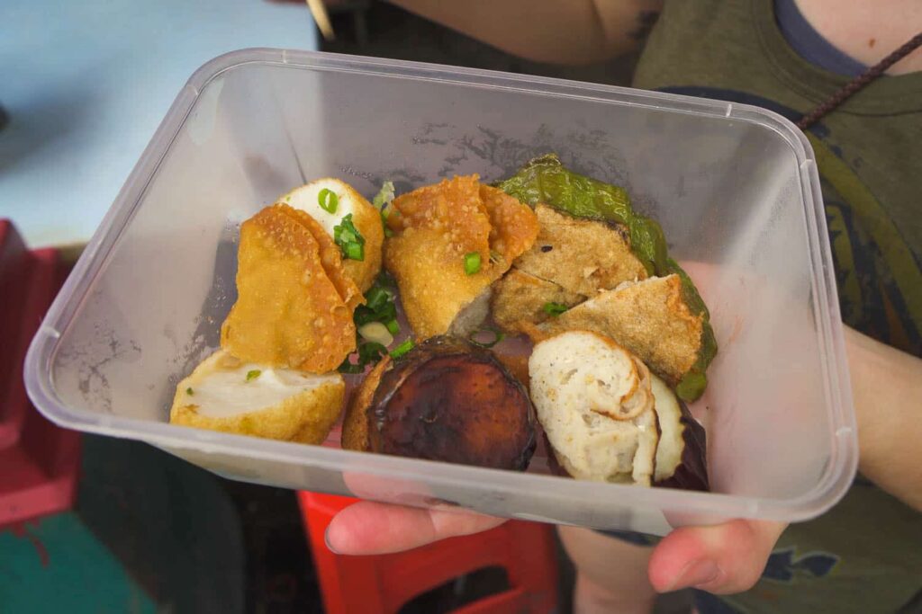 Container full of yong tau foo, vegetables and tofu stuffed with fish paste
