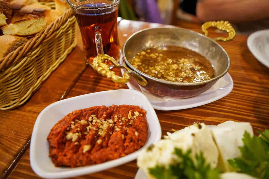 Roasted red pepper dip in bowl with bread 