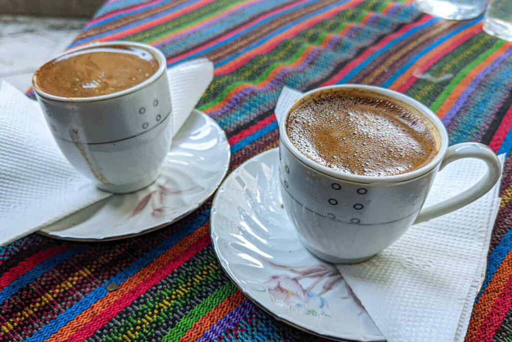 Two cups of strong Turkish tea on saucers on table with Ottoman motifs