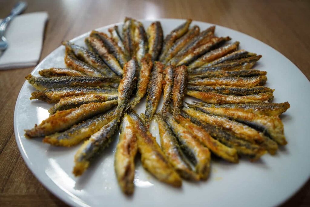 Plate of hamsi tava fried anchovy in circular spiral shape