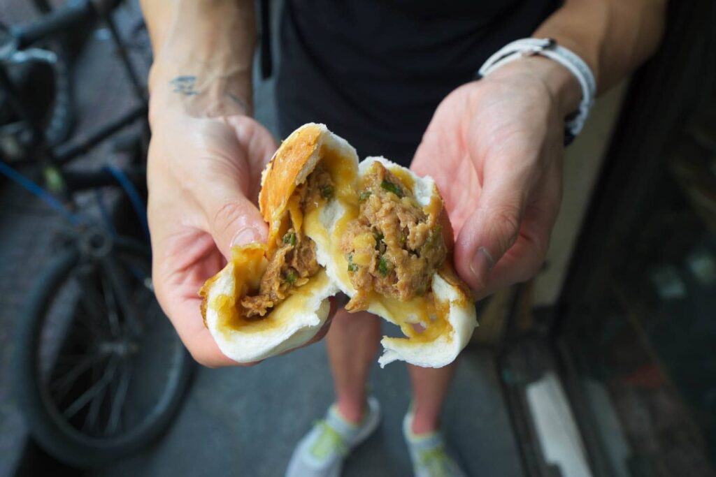 Ripped open fried siopao full of pork top street food in Binondo