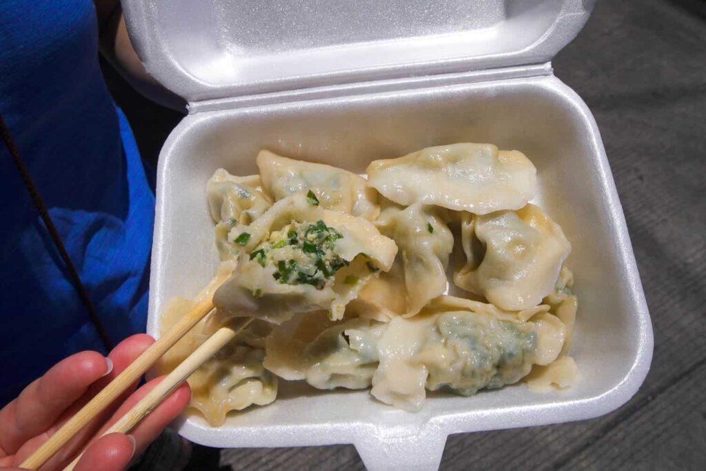 Pork and chive filled insides of dumplings in box top street food in Binondo