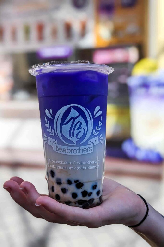 Ube bubble milk tea in hand top food Binondo