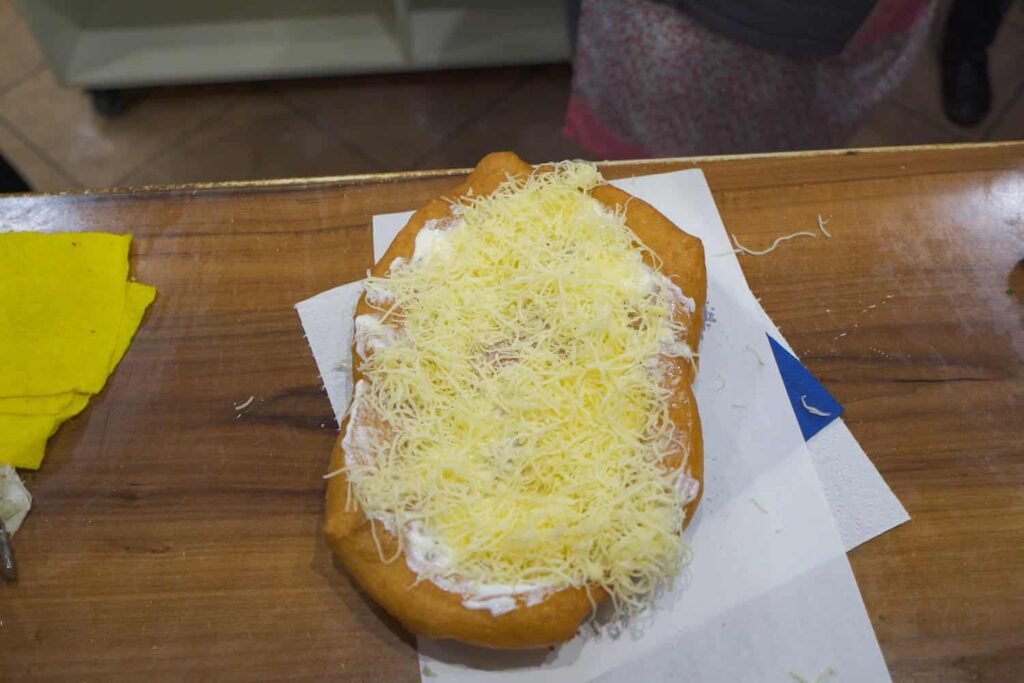 Sour cream, cheese and garlic langos on table