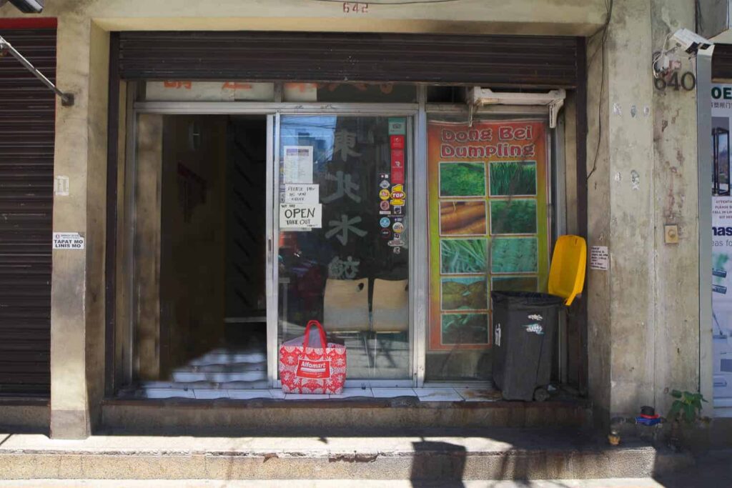 Front of Dong Bei Dumpling shop window with colourful sign