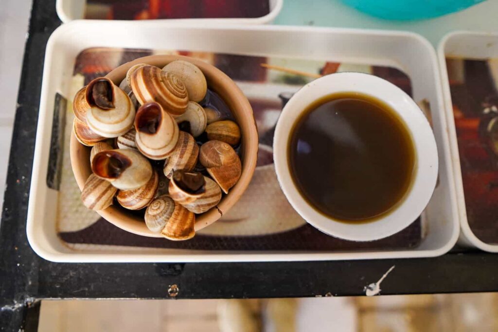 Moroccan snail soup on tray with bowl of spiced broth