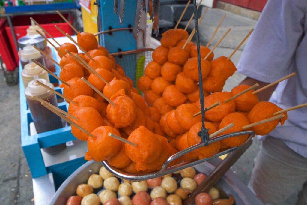 Basket of orange kwek kwek on street food cart Quiapo market best foods