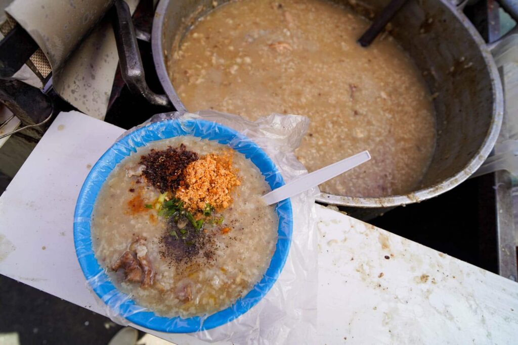 Aerial view of bowl of lugaw rice porridge with spices and beef