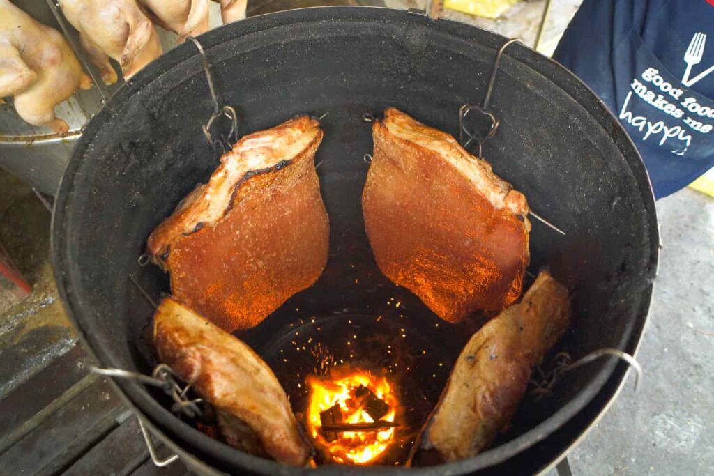 the best siu yuk in kuala lumpur slabs of pork belly roasting in fiery drum