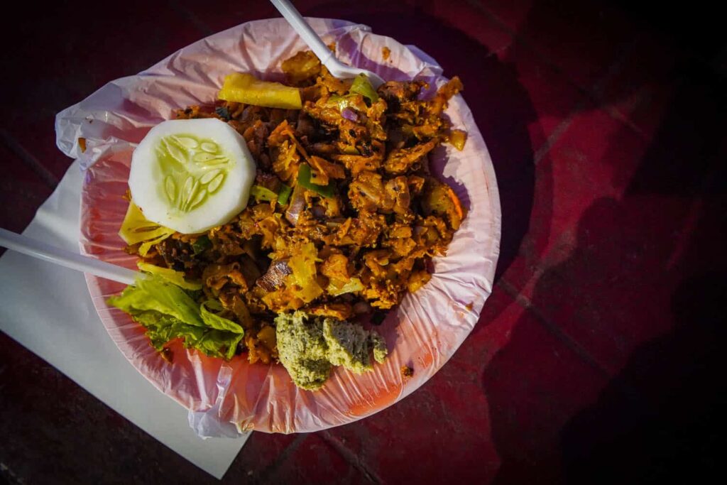 Plate of kottu roti sitting on red table