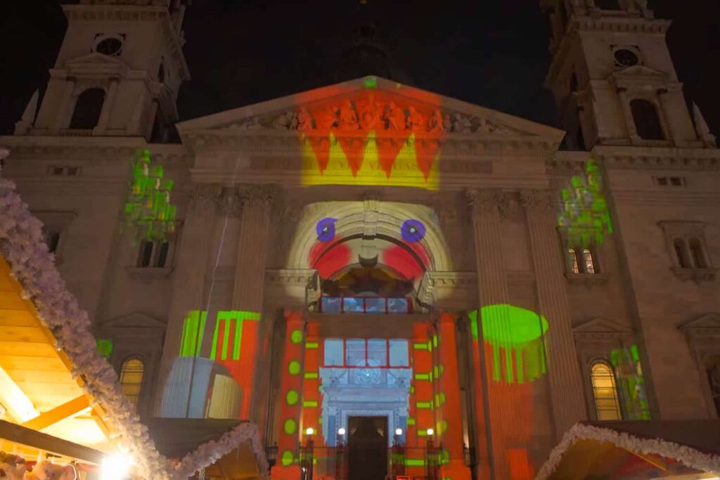 The facade of St. Stephen's Basilica illuminated with a large nutcracker.